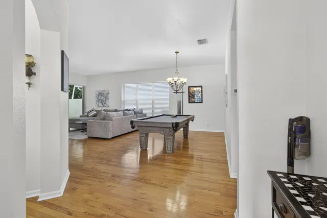 a kitchen with refrigerator a stove a sink and a dining table