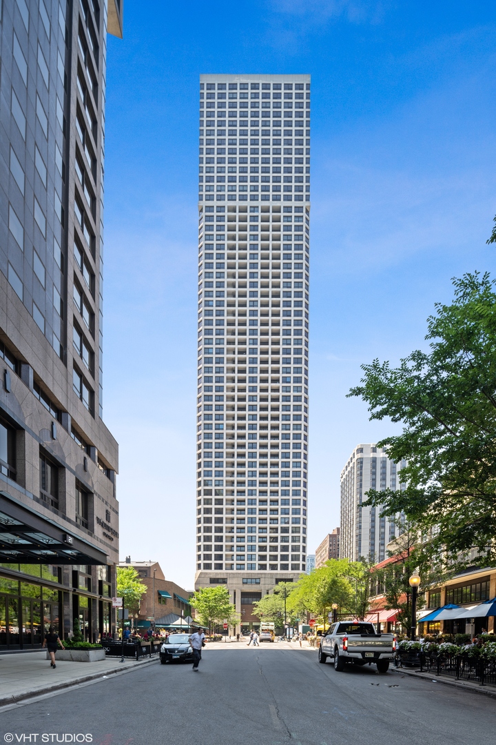 1030 North State Street, Unit 9K Chicago, IL 60610 - Photo 1 of 12 a city street lined with buildings and cars