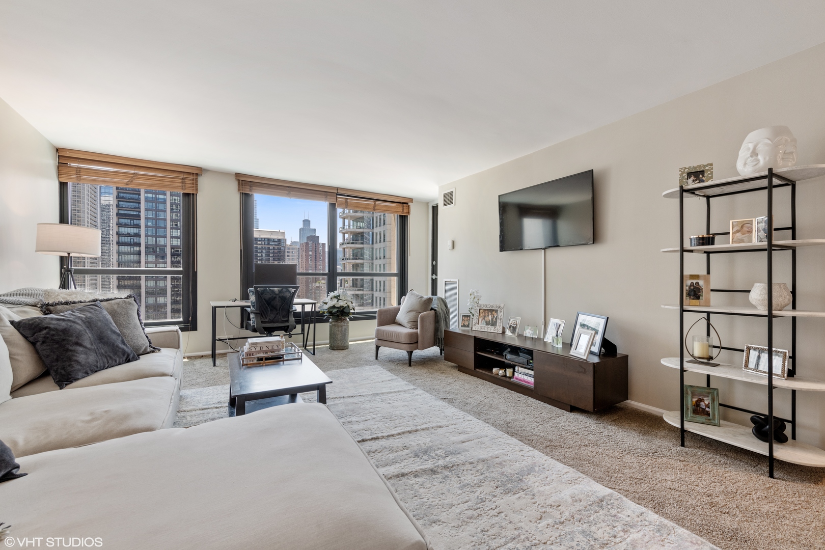 1030 North State Street, Unit 9K Chicago, IL 60610 - Photo 7 of 12 a living room with furniture and a flat screen tv