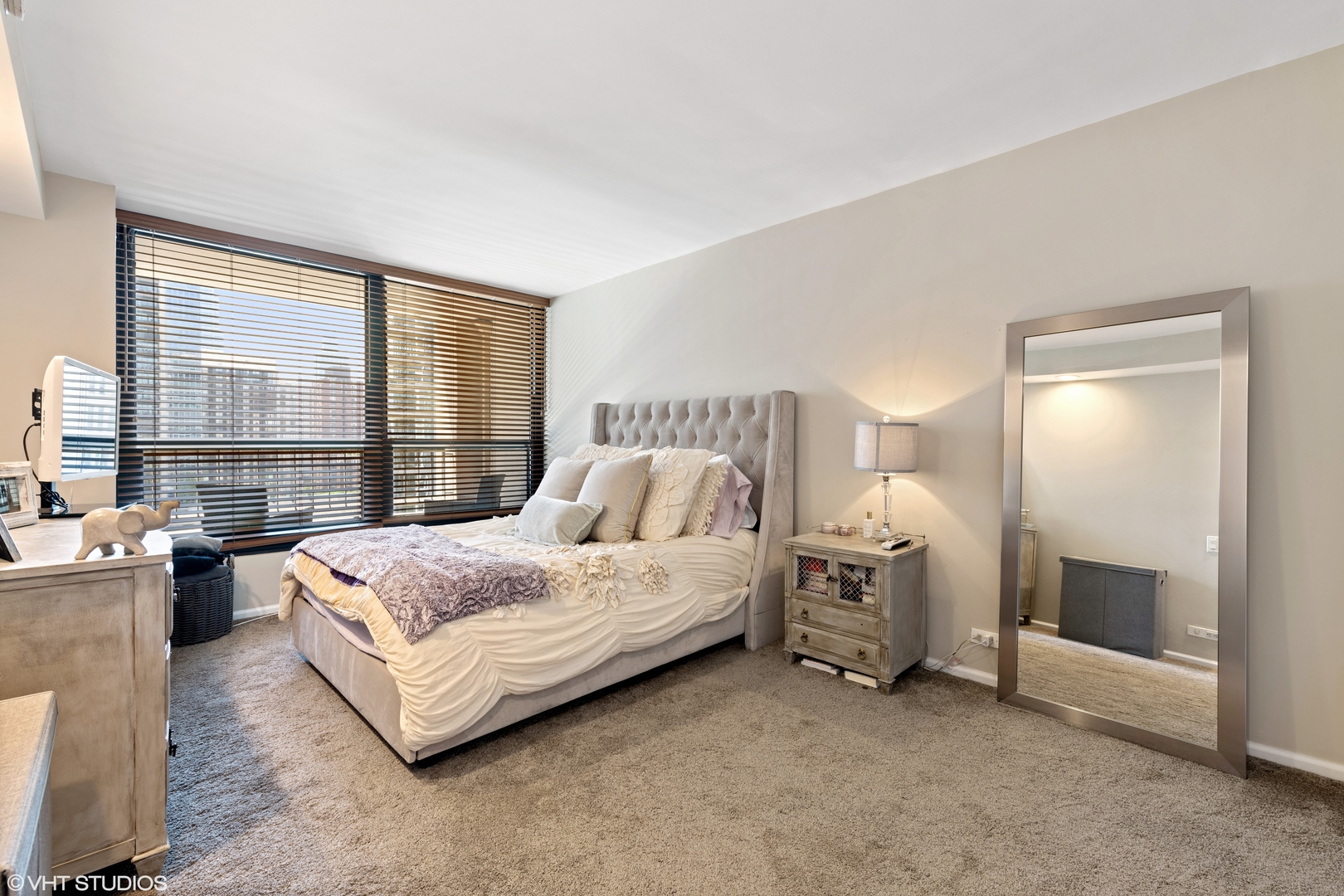 1030 North State Street, Unit 9K Chicago, IL 60610 - Photo 8 of 12 a spacious bedroom with a bed and a large window