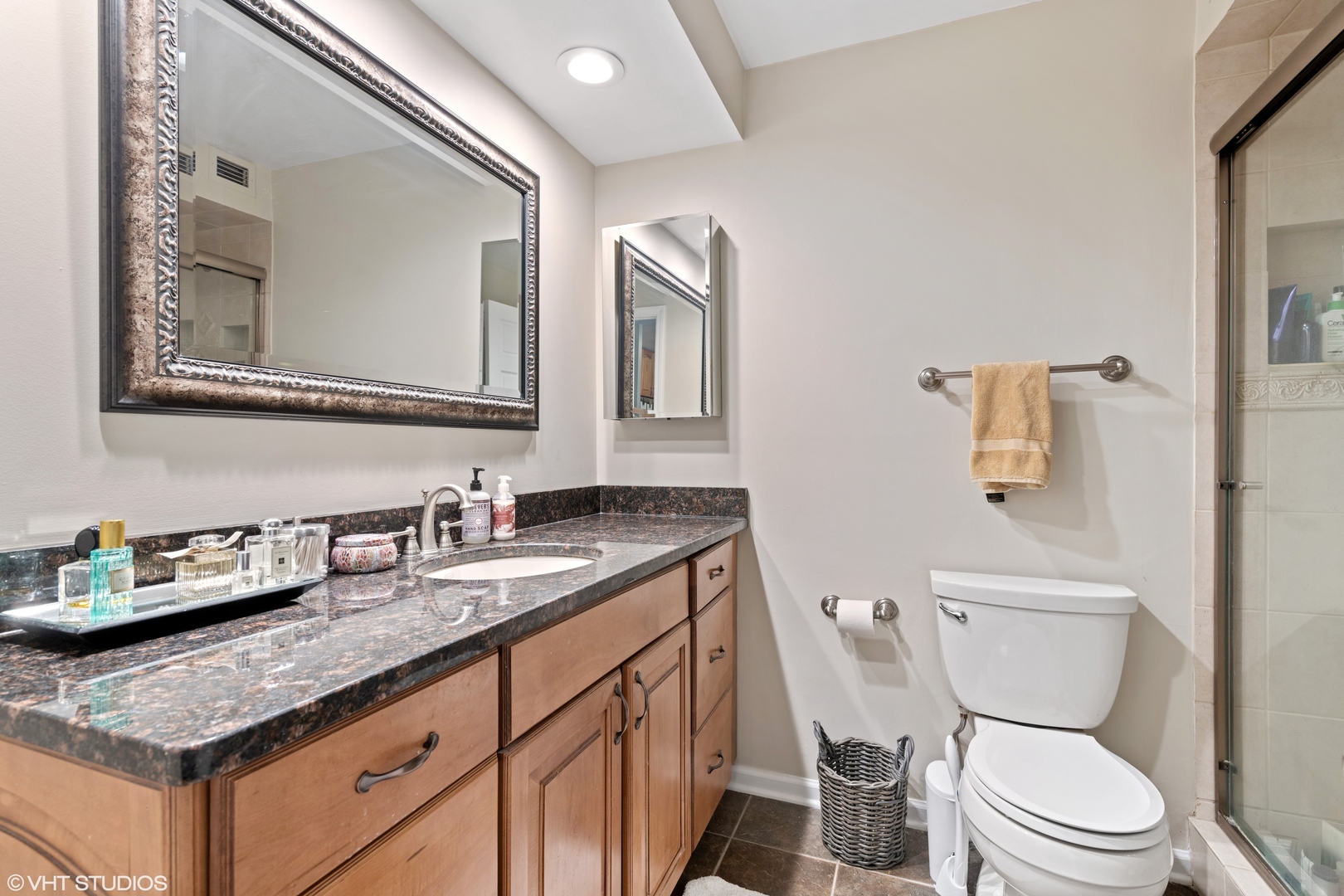1030 North State Street, Unit 9K Chicago, IL 60610 - Photo 10 of 12 a bathroom with a granite countertop toilet sink and mirror