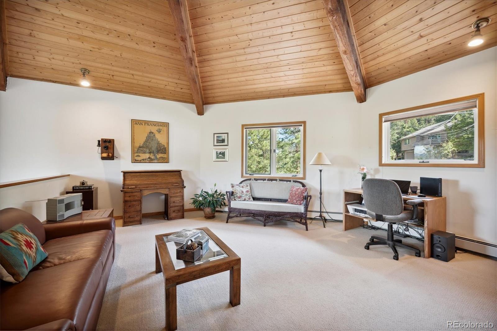 4671 Independence Trail Evergreen, CO 80439 - Photo 12 of 39 a living room with furniture a fireplace and a window