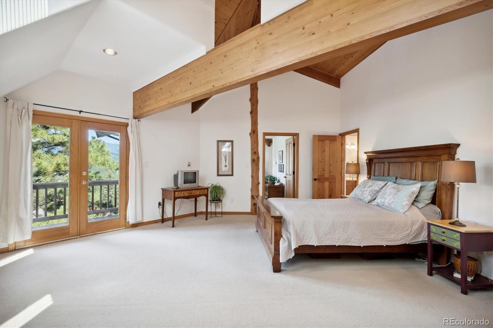 4671 Independence Trail Evergreen, CO 80439 - Photo 16 of 39 a bedroom with a bed and a large window