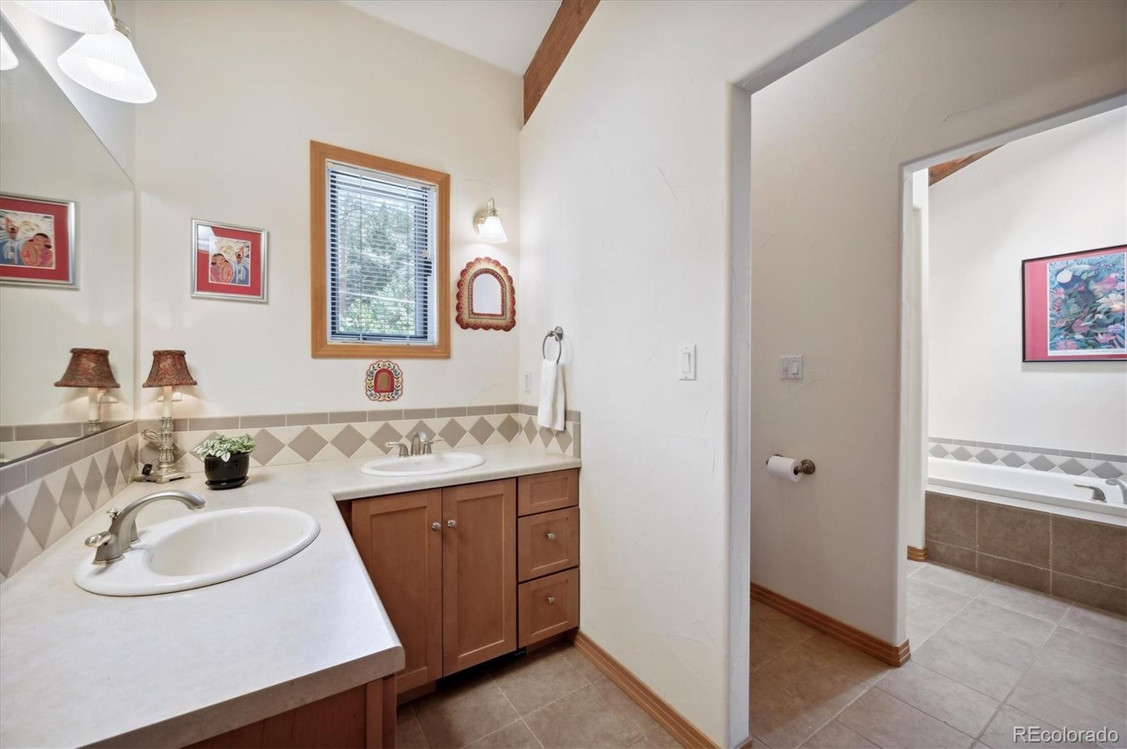 4671 Independence Trail Evergreen, CO 80439 - Photo 17 of 39 a bathroom with a sink and a mirror