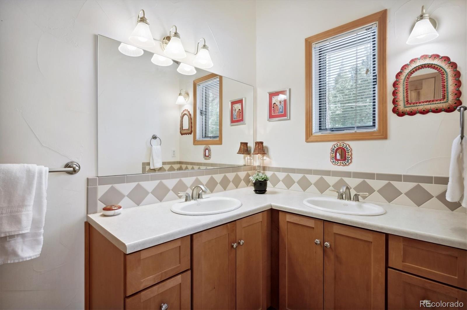 4671 Independence Trail Evergreen, CO 80439 - Photo 18 of 39 a bathroom with a sink and a mirror