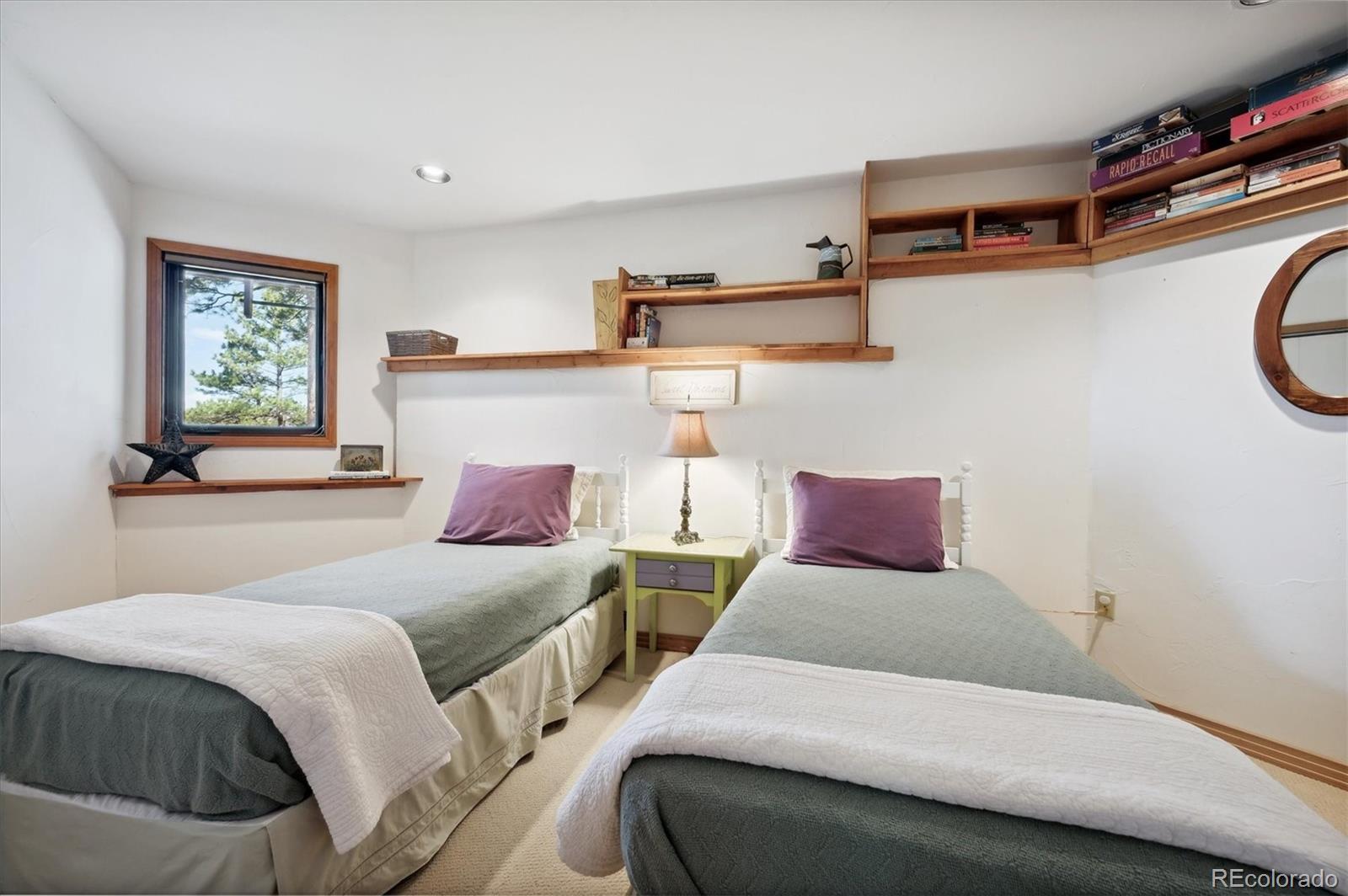 4671 Independence Trail Evergreen, CO 80439 - Photo 22 of 39 a bedroom with a bed and window