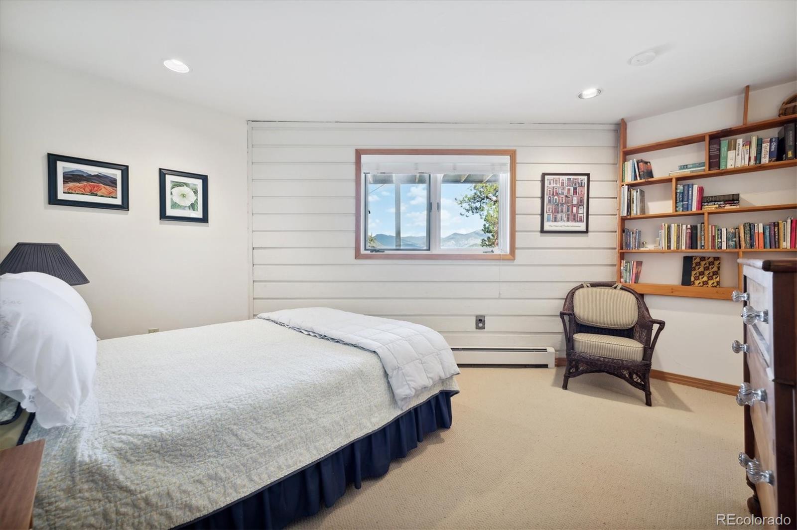4671 Independence Trail Evergreen, CO 80439 - Photo 23 of 39 a bedroom with a bed and a chair