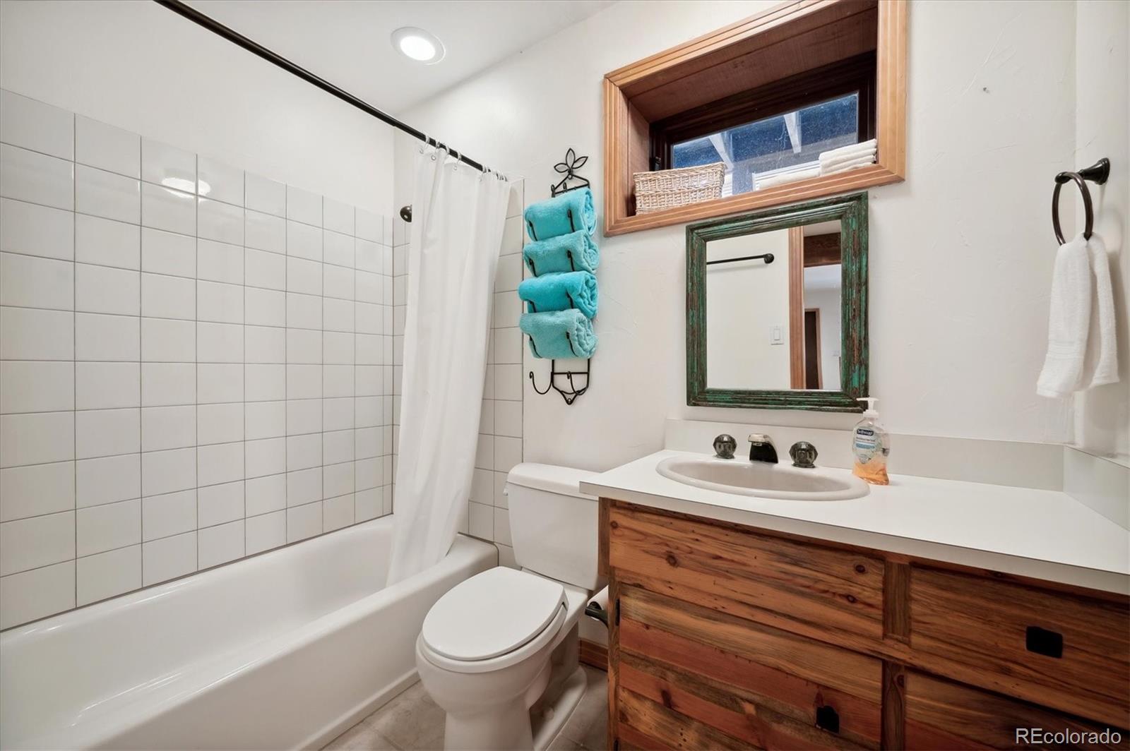 4671 Independence Trail Evergreen, CO 80439 - Photo 24 of 39 a bathroom with a sink a toilet and shower