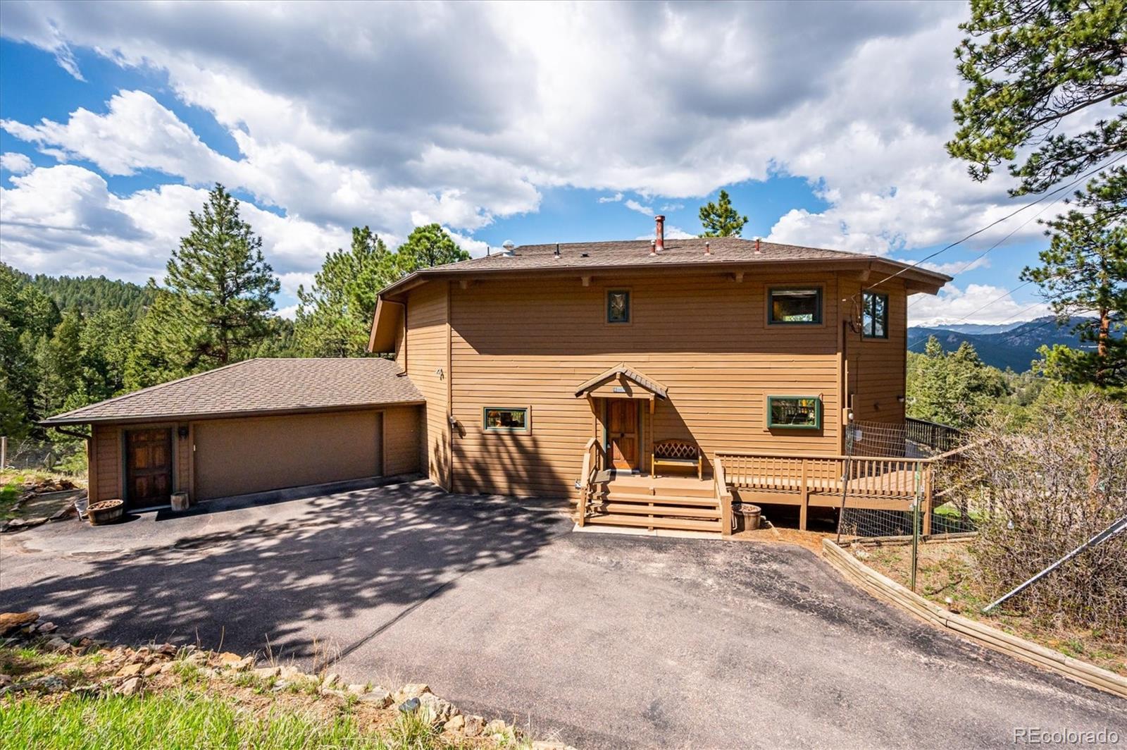 4671 Independence Trail Evergreen, CO 80439 - Photo 29 of 39 a front view of a house with a garden