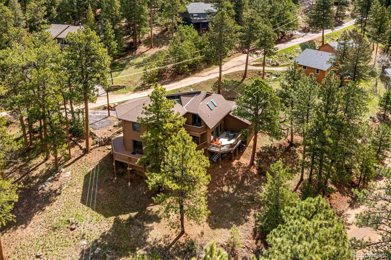 4671 Independence Trail Evergreen, CO 80439 - Photo 34 of 39 a view of a house with a yard and sitting area