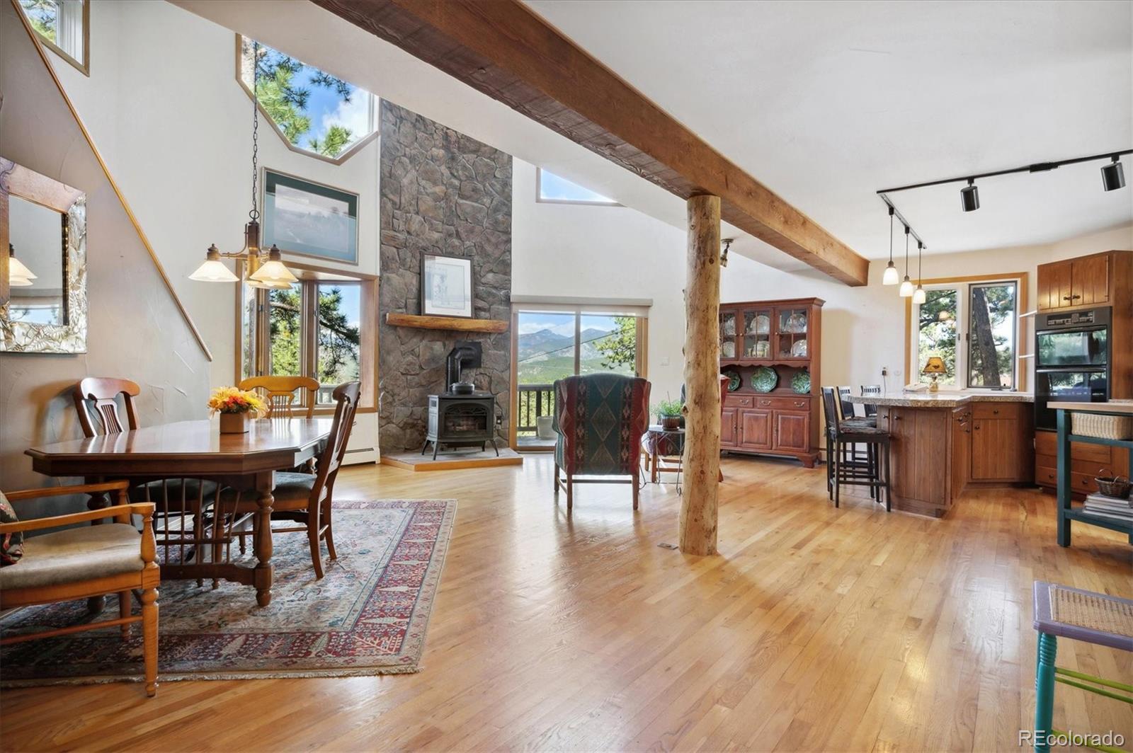 4671 Independence Trail Evergreen, CO 80439 - Photo 6 of 39 a living room with furniture a fireplace and wooden floor