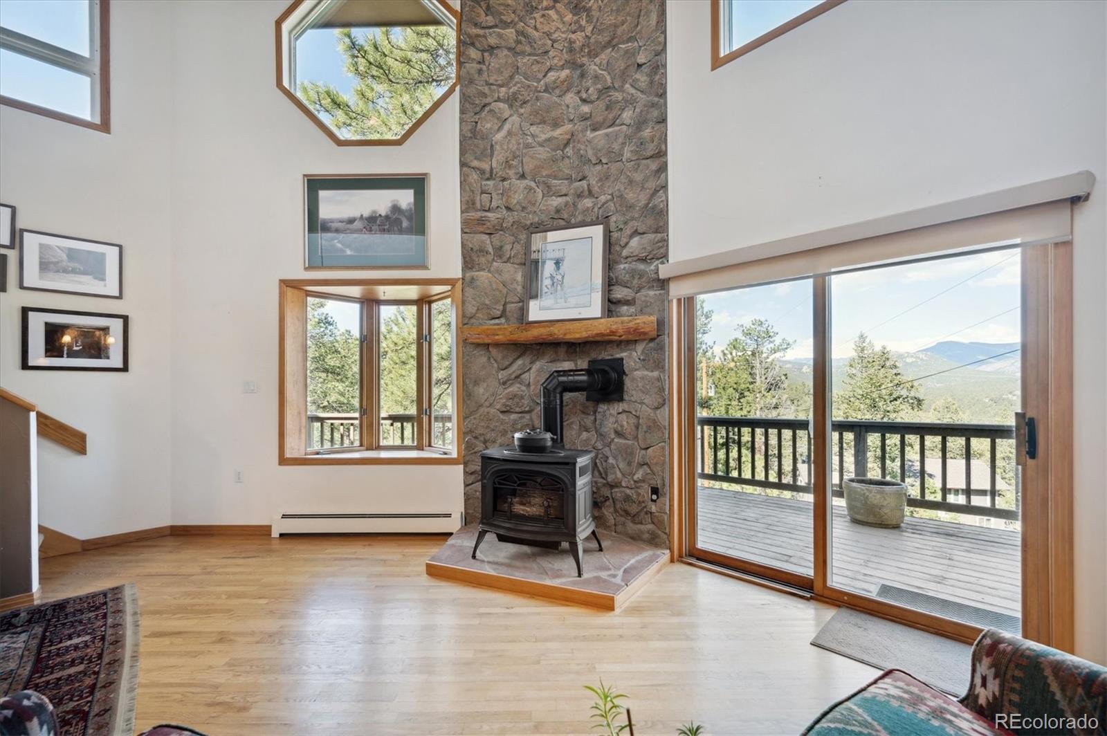 4671 Independence Trail Evergreen, CO 80439 - Photo 8 of 39 a living room with furniture and a fireplace