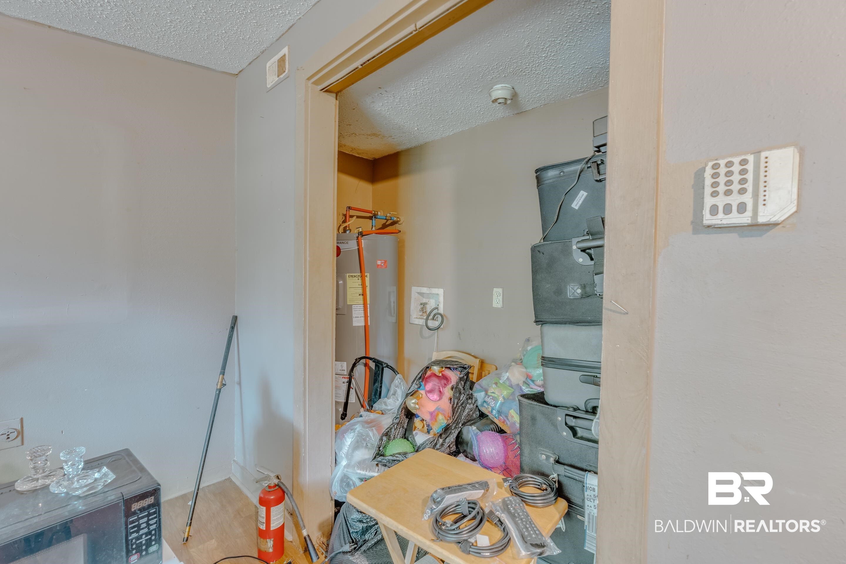 1156 Freeman Street Mobile, AL 36605 - Photo 13 of 22 Bathroom featuring water heater, a textured ceiling, and visible vents