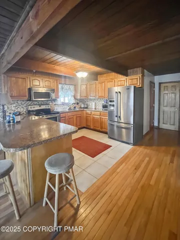 a large kitchen with lots of counter top space and stainless steel appliances