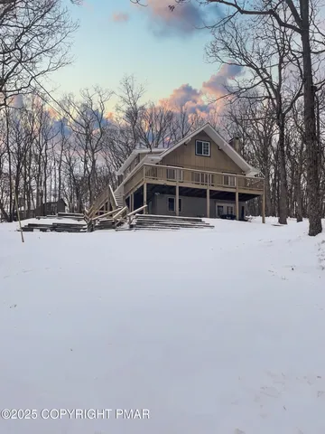 a view of house with a snow in the background