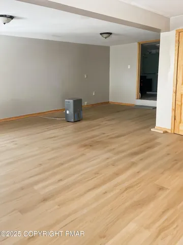 a bed sitting in a bedroom next to a larger window