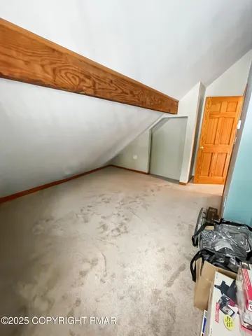a view of a hallway with wooden floor and chandelier