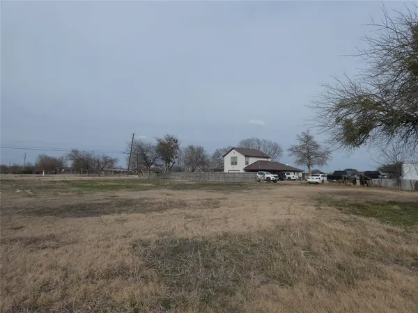 a view of a field and trees