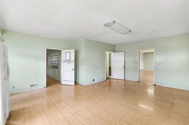 an empty room with closet and windows