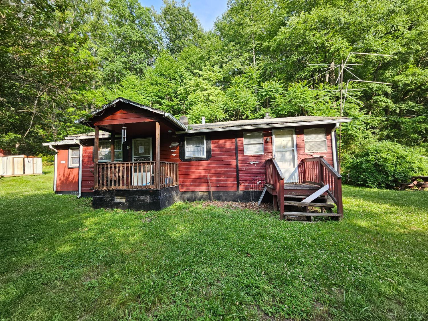 a view of a chair and table in backyard of the house