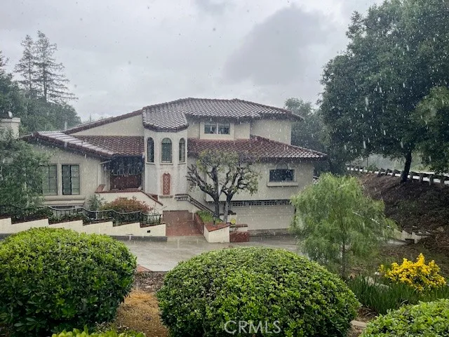 a front view of a house with a garden