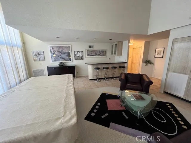 a living room with furniture and large window