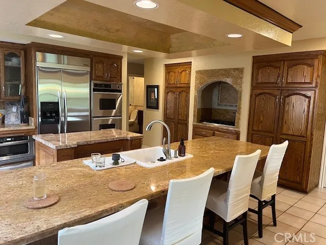 a kitchen with stainless steel appliances a stove a microwave and a refrigerator