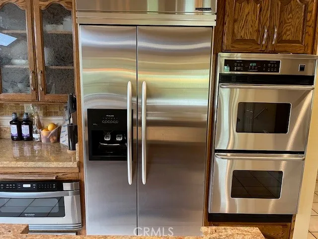 a stove top oven sitting inside of a kitchen