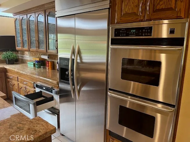 a kitchen with stainless steel appliances granite countertop a sink and a microwave