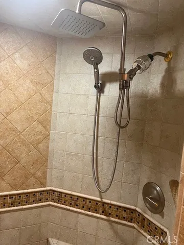 a bedroom with a bed and a lamp next to a window