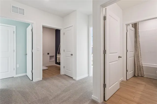 a view of a livingroom with a walk in closet and wooden floor