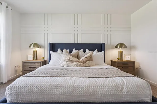 a bedroom with a bed and window