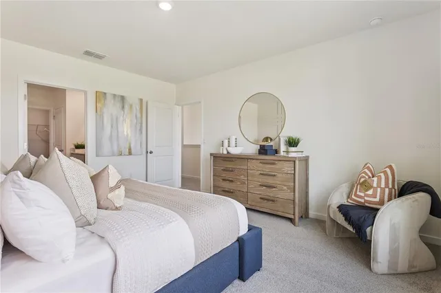 a bedroom with a bed and a dresser