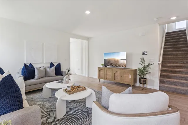 a living room with furniture and a lamp