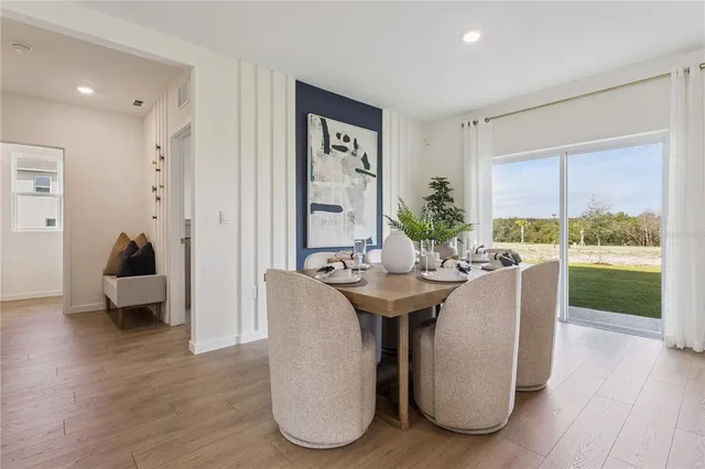 a living room with furniture a table and large windows