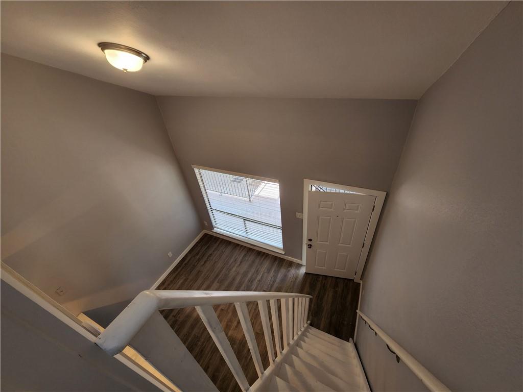 2815 Rio Grande Street, Unit 215 Austin, TX 78705 - Photo 11 of 11 A welcoming entryway features wood plank flooring and a crisp white door, illuminated by natural light from a well-placed window.