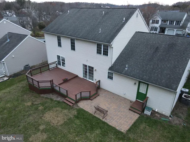 an aerial view of a house with backyard space and garden