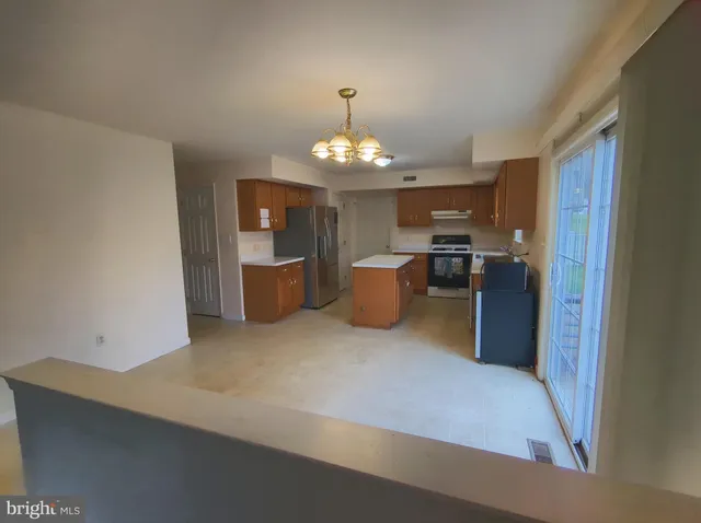 a kitchen with cabinets and stainless steel appliances