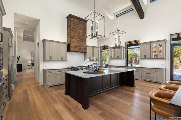 a kitchen with counter top space and view of living room
