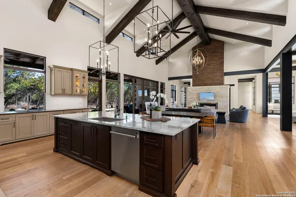 a kitchen with granite countertop a refrigerator stove and sink