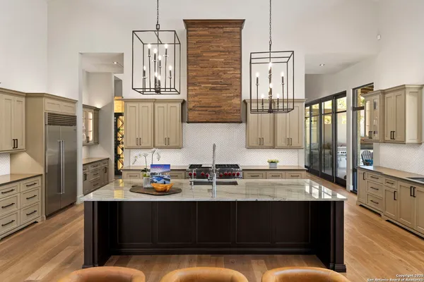 a kitchen with stainless steel appliances granite countertop a sink and a stove