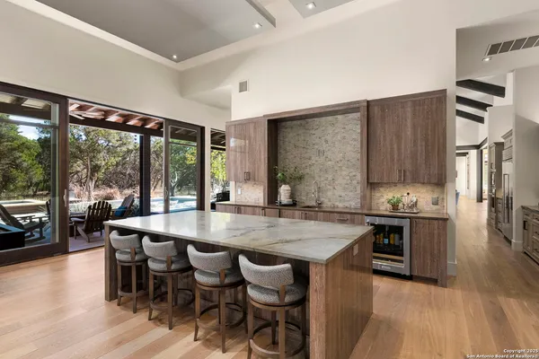 a large white kitchen with a large window