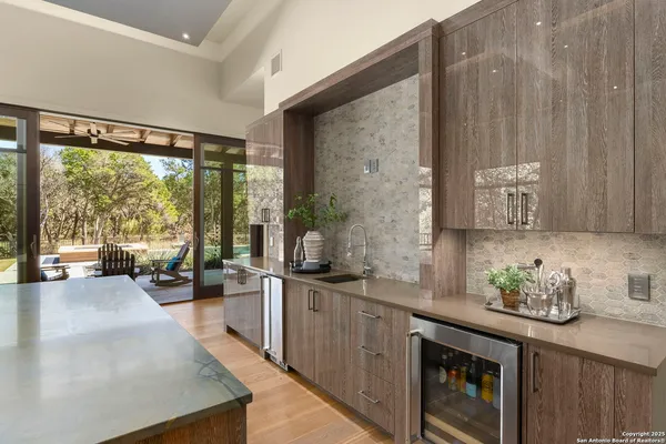 a large living room with stainless steel appliances granite countertop a large window