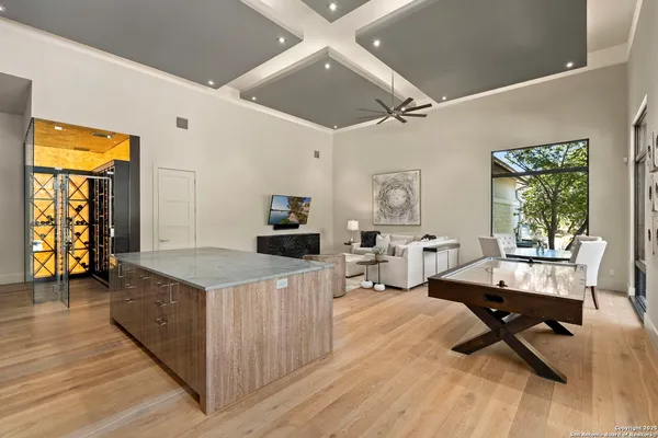 a large white kitchen with a large window and stainless steel appliances