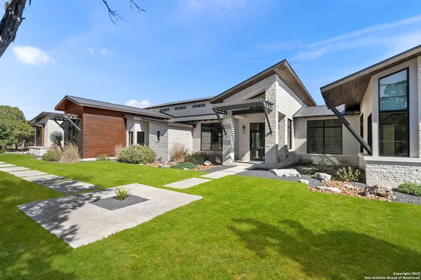 a front view of a house with yard and green space