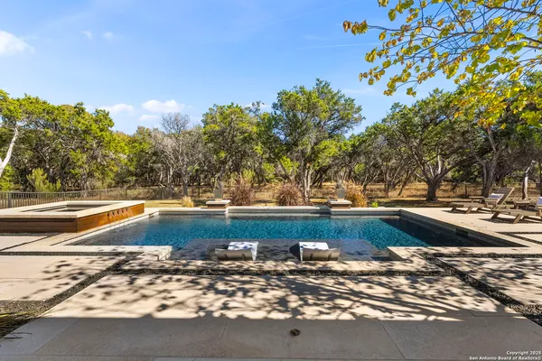 an aerial view of a house with swimming pool garden and mountain view