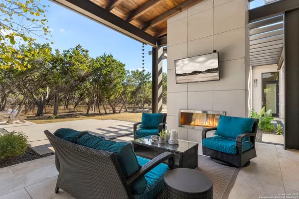 an aerial view of a house with swimming pool and outdoor seating
