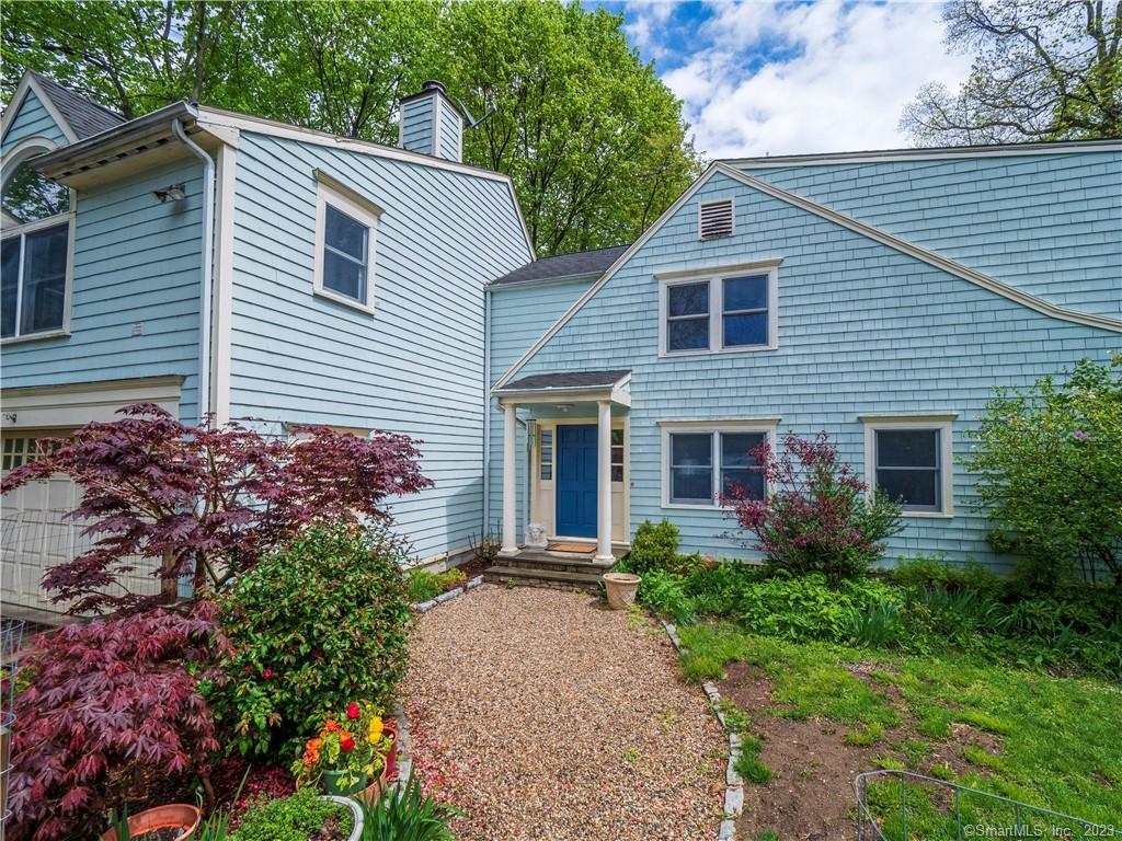 1086 Ridgefield Road Wilton, CT 06897 - Photo 1 of 1 a view of a house with potted plants and a large tree