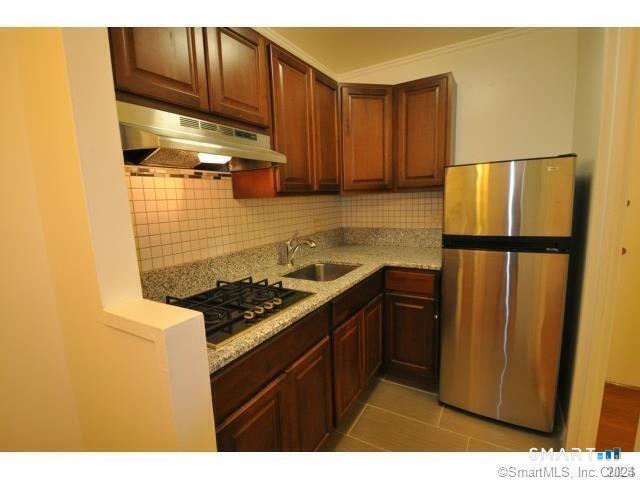99 Prospect Street, Unit 5M Stamford, CT 06901 - Photo 5 of 10 a kitchen with stainless steel appliances granite countertop a refrigerator and a stove