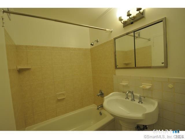 99 Prospect Street, Unit 5M Stamford, CT 06901 - Photo 7 of 10 a bathroom with a sink mirror and vanity